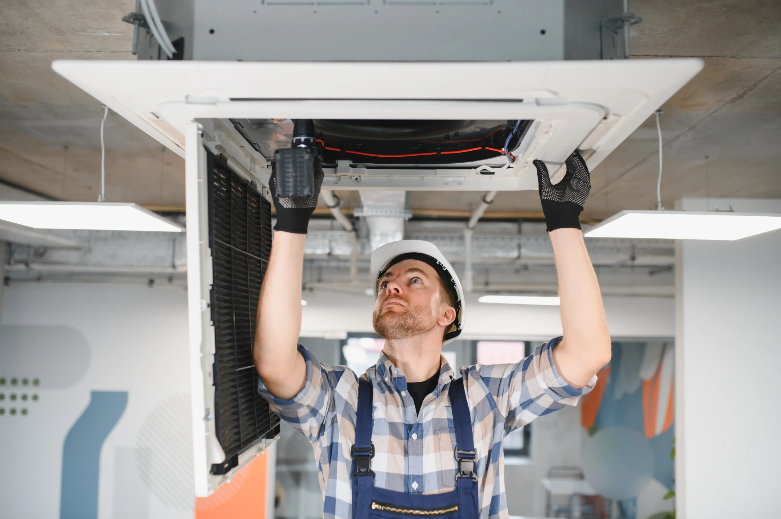 hvac-technician-repairing-air-conditioning-unit-ceiling (1)